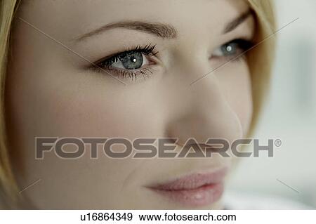 Stock Photo - Side portrait of a woman, close up.. Fotosearch