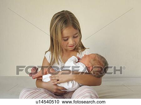 Sister holding baby View Large Photo Image Stock Image - Sister holding baby. Fotosearch