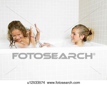 Picture - Sisters playing in a bath, foam. Fotosearch