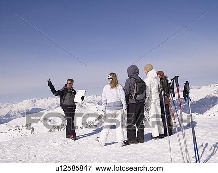 Stock Photo - ski instructor teaching class. Fotosearch