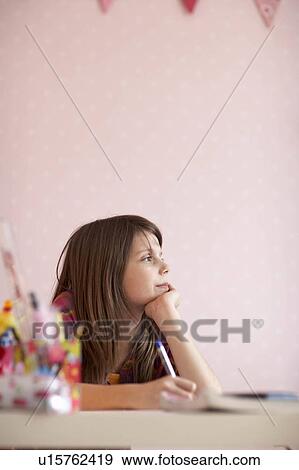 Teenage girl doing homework View Large Photo Image Stock Photo - Teenage girl doing homework. Fotosearch