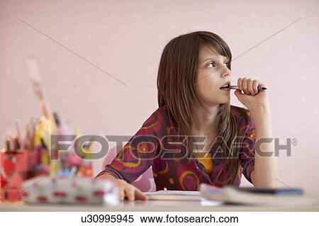 Teenage girl doing homework View Large Photo Image Stock Photography - Teenage girl doing homework. Fotosearch