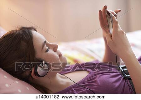 Teenage girl listening to music View Large Photo Image Stock Image - Teenage girl listening to music. Fotosearch
