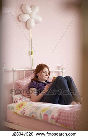 Teenage girl reading in bedroom View Large Photo Image Stock Image - Teenage girl reading in bedroom. Fotosearch
