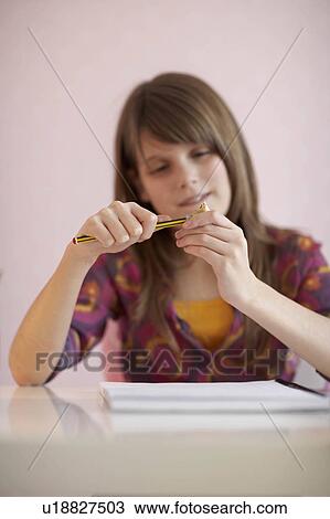 Teenage girl sharpening pencil View Large Photo Image Stock Image - Teenage girl sharpening pencil. Fotosearch