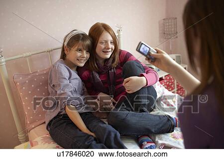 Teenage girl taking photo on phone View Large Photo Image Stock Image - Teenage girl taking photo on phone. Fotosearch