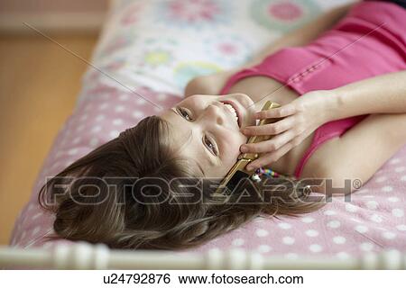 Teenage girl using mobile phone View Large Photo Image Stock Photograph - Teenage girl using mobile phone. Fotosearch