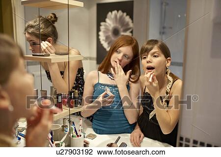 Teenage girls applying make-up View Large Photo Image Stock Image - Teenage girls applying make-up. Fotosearch