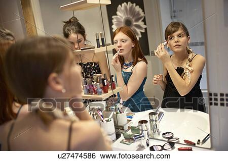 Teenage girls applying make-up View Large Photo Image Stock Photograph - Teenage girls applying make-up. Fotosearch