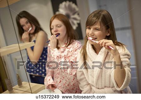 Teenage girls brushing teeth View Large Photo Image Stock Photo - Teenage girls brushing teeth. Fotosearch