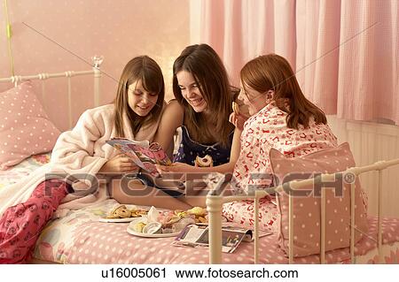 Teenage girls reading magazines View Large Photo Image Stock Image - Teenage girls reading magazines. Fotosearch