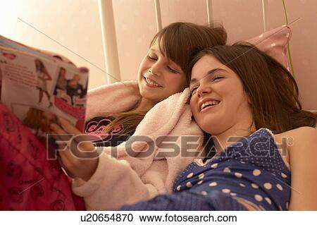 Teenage girls reading magazines View Large Photo Image Stock Image - Teenage girls reading magazines. Fotosearch