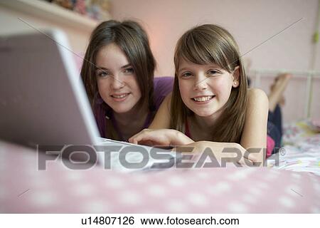 Teenage girls using laptop View Large Photo Image Stock Photograph - Teenage girls using laptop. Fotosearch