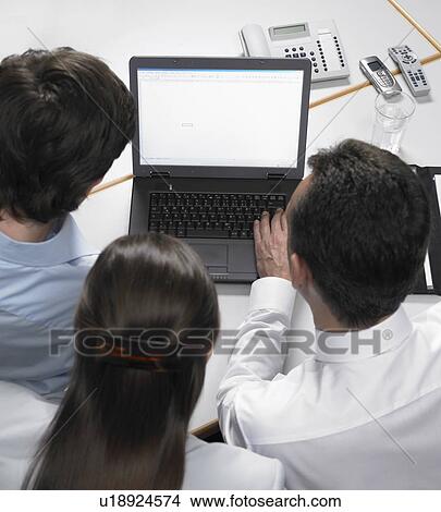 Three Businesspeople using laptop View Large Photo Image Picture - Three Businesspeople using laptop. Fotosearch