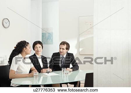 Stock Image - Three colleagues talking. Fotosearch