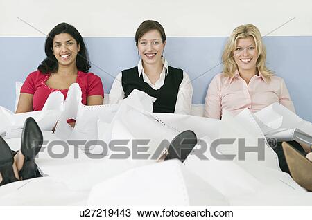 Three female colleagues sitting in bed View Large Photo Image Stock Image - Three female colleagues sitting in bed. Fotosearch