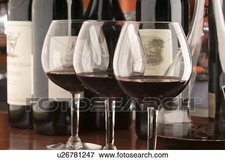 Three red wine glasses and bottles View Large Photo Image Stock Photo - Three red wine glasses and bottles. Fotosearch