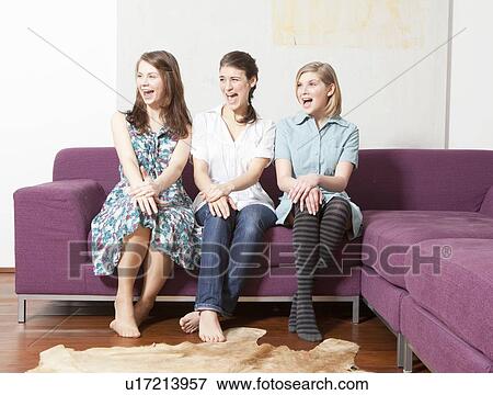 Three women on a sofa, screaming. View Large Photo Image Stock Photo - Three women on a sofa, screaming.. Fotosearch