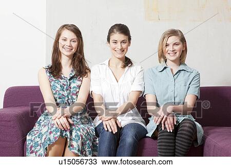 Three women on a sofa View Large Photo Image Stock Image - Three women on a sofa. Fotosearch