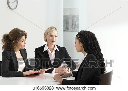 Two business women conduct an interview View Large Photo Image Stock Photo - Two business women conduct an interview. Fotosearch