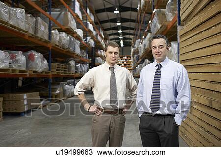 Two businessmen in warehouse, portrait View Large Photo Image Stock Image - Two businessmen in warehouse, portrait. Fotosearch