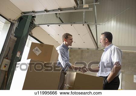 Two businessmen in warehouse View Large Photo Image Stock Photograph - Two businessmen in warehouse. Fotosearch
