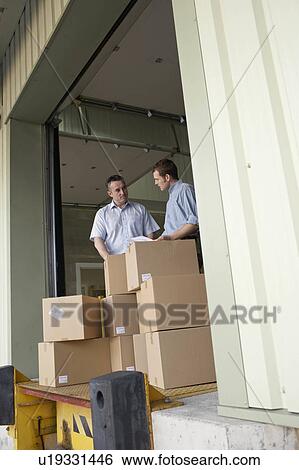 Two businessmen in warehouse View Large Photo Image Stock Photograph - Two businessmen in warehouse. Fotosearch
