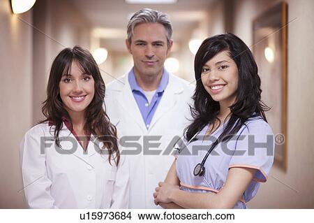 Picture - Two Doctors and female nurse smiling. Fotosearch