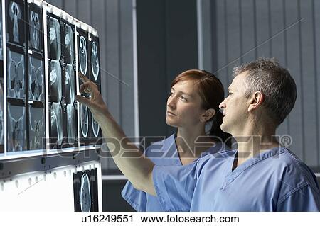 Two doctors looking at x-rays View Large Photo Image Stock Image - Two doctors looking at x-rays. Fotosearch