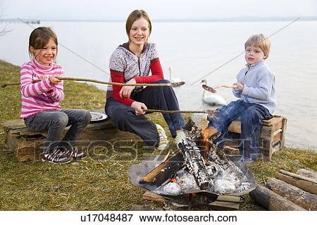 two girls and boy roasting sausages View Large Photo Image Stock Photo - two girls and boy roasting sausages. Fotosearch