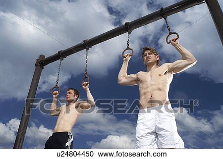 two guys on pull up rings View Large Photo Image Stock Image - two guys on pull up rings. Fotosearch