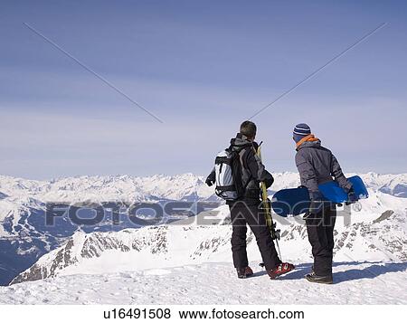 Stock Photo - two men viewing mountains. Fotosearch