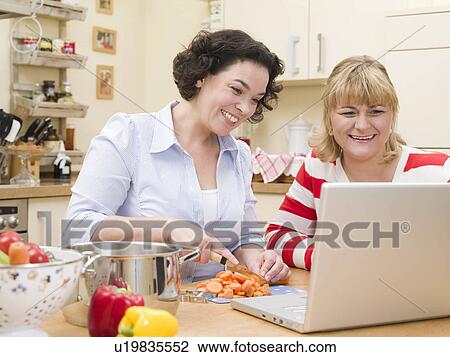 Stock Image - Two women cooking.. Fotosearch