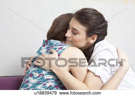 Stock Photo - Two women embracing.. Fotosearch