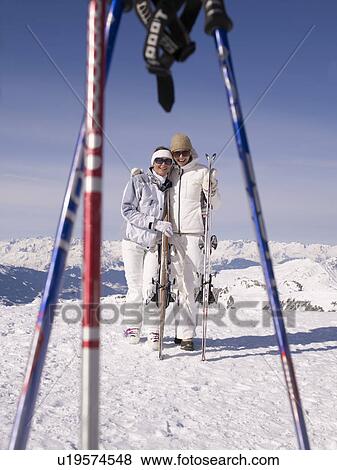 two women with skis smiling at viewer View Large Photo Image Stock Photo - two women with skis smiling at viewer. Fotosearch