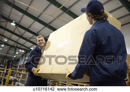 Stock Image - Two workers carrying large box. Fotosearch