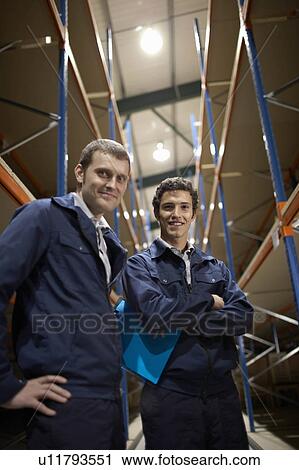 Two workers in warehouse View Large Photo Image Stock Image - Two workers in warehouse. Fotosearch