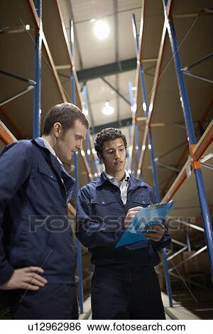 Two workers in warehouse View Large Photo Image Stock Photograph - Two workers in warehouse. Fotosearch
