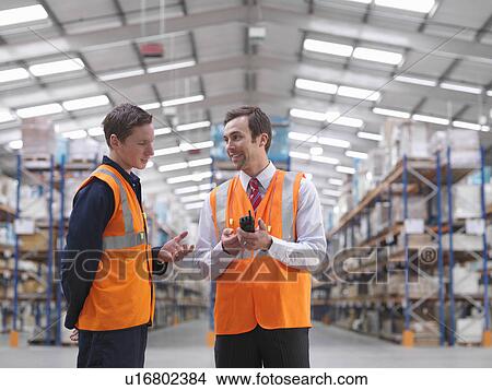 Warehouse Manager Talking To Worker View Large Photo Image Picture - Warehouse Manager Talking To Worker. Fotosearch