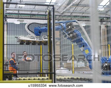 Picture - Warehouse Workers With Robot. Fotosearch