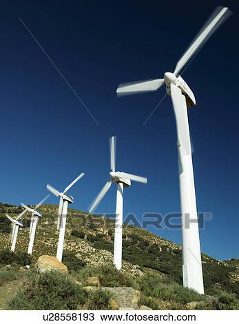 Wind turbines against stormy sky View Large Photo Image Stock Image - Wind turbines against stormy sky. Fotosearch