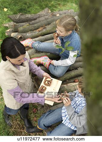 Woman and children eating applecake View Large Photo Image Stock Photo - Woman and children eating applecake. Fotosearch