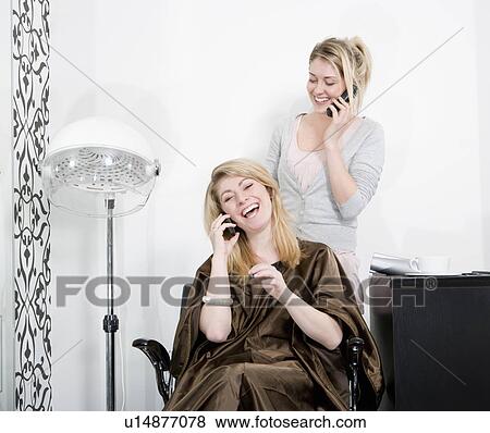 Stock Photo - Woman and hair stylist on phones. Fotosearch
