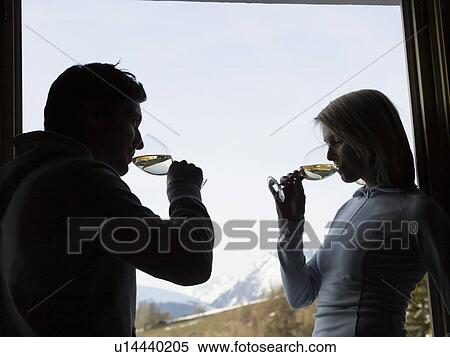 Stock Photography - woman and man at window drinking. Fotosearch