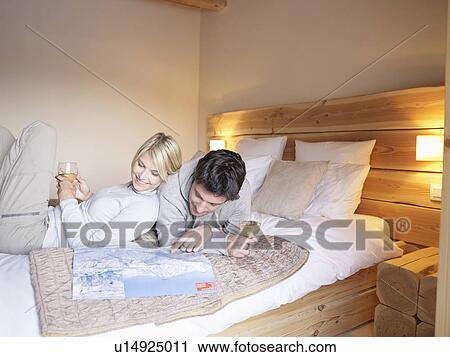 woman and man lying on reading map View Large Photo Image Stock Image - woman and man lying on reading map. Fotosearch