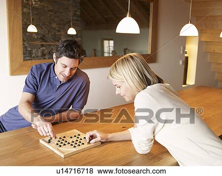 woman and man playing game at the table View Large Photo Image Stock Photo - woman and man playing game at the table. Fotosearch