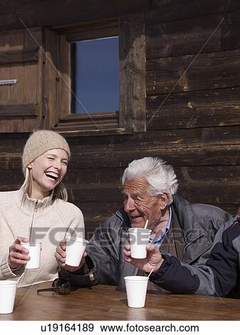 woman and old man with cups laughing View Large Photo Image Stock Photo - woman and old man with cups laughing. Fotosearch