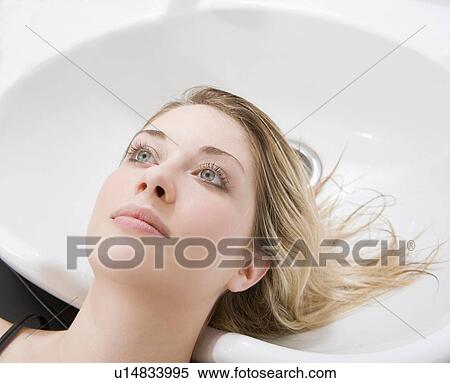 Stock Photography - woman at sink at hairdressers. Fotosearch