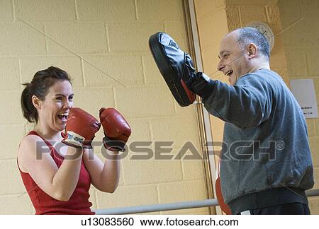 Stock Image - woman boxing exercise at gym. Fotosearch