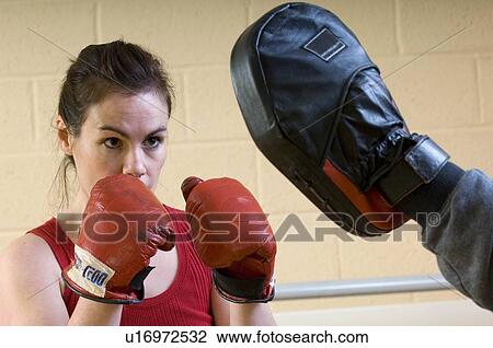 Stock Image - woman boxing exercise at gym. Fotosearch